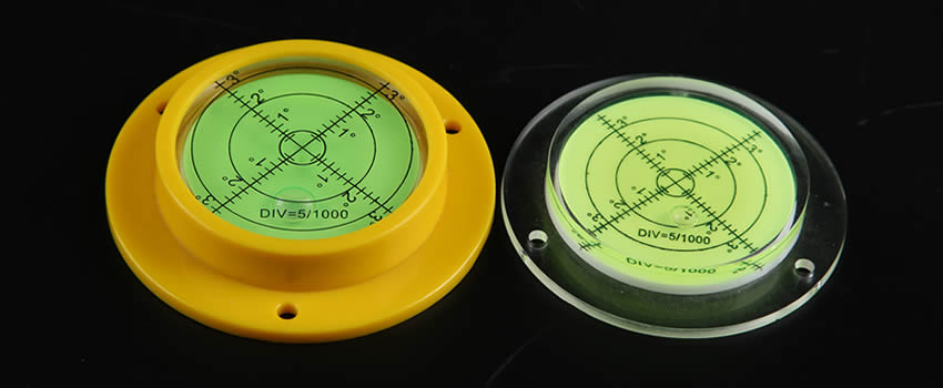 Two plastic bubble level vials. Both are pre-drilled holes.